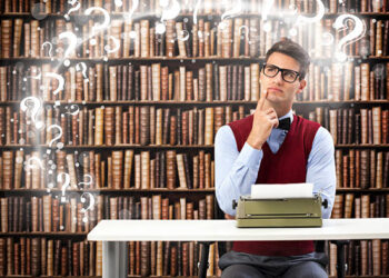 Male student writer on desk with typewriter