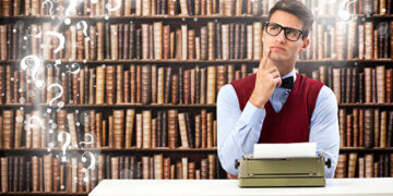 Male student writer on desk with typewriter