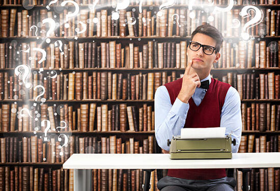 Male student writer on desk with typewriter