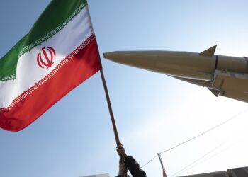 A young boy is waving an Iranian flag next to the Iranian-made Zolfaghar missile on display at Azadi (Freedom) Square in western Tehran, Iran, on February 11, 2024, during a rally to mark the 45th anniversary of the victory of Iran's 1979 Islamic Revolution. The Iranian Islamic Revolution, which led to the overthrow of the Pahlavi dynasty in 1979, replaced the Imperial State of Iran with the present-day Islamic Republic of Iran. (Photo by Morteza Nikoubazl/NurPhoto via Getty Images)